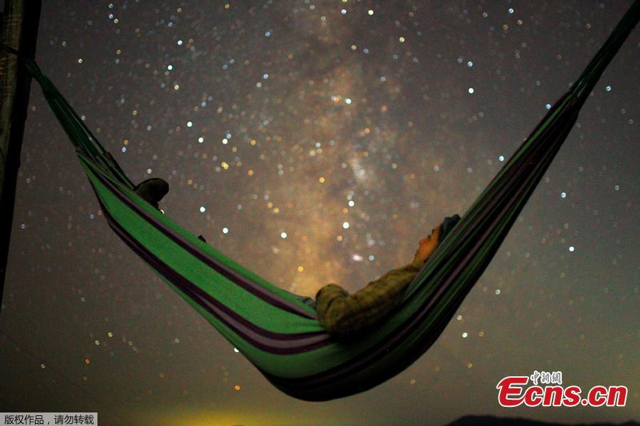 A girl lies in hammock as she looks at the milky way during the peak of Perseid meteor shower in Kozjak, Macedonia August 13, 2018. The so-called Perseids meteor shower returns to the skies every August and are best viewed in the northern hemisphere in isolated areas where there is little light pollution. (Photo/Agencies)