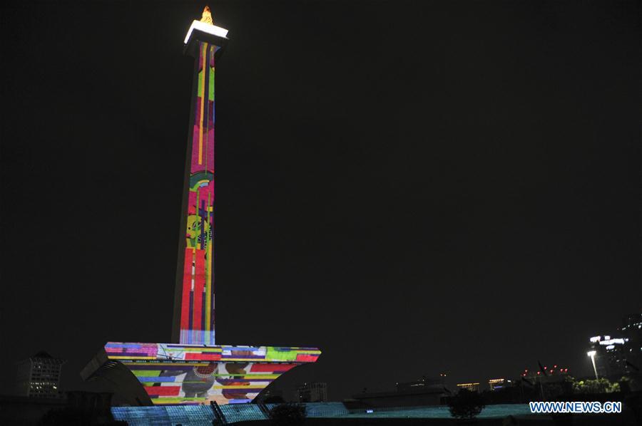 A video mapping work is projected on the facade of the National Monument also known as Monas to welcome the Asian Games in Jakarta, Indonesia, Aug. 13, 2018. (Xinhua/Zulkarnain)