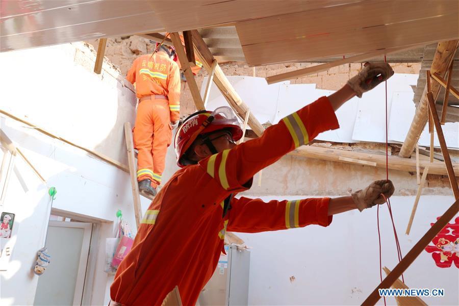 A rescuer works at a damaged house in Tonghai County, southwest China\'s Yunnan Province, Aug. 13, 2018. Eighteen people were injured after a magnitude-5 earthquake jolted Yunnan Province Monday morning, local authorities have said. The quake affected more than 48,000 residents in the counties of Tonghai and Huaning and the district of Jiangchuan, all administered by the city of Yuxi, damaging over 6,000 homes, according to a statement from the provincial civil affairs department. (Xinhua/Wang Anhaowei)
