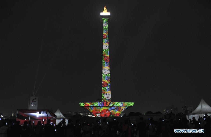 A video mapping work is projected on the facade of the National Monument also known as Monas to welcome the Asian Games in Jakarta, Indonesia, Aug. 13, 2018. (Xinhua/Zulkarnain)