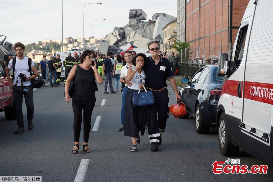 A woman cries being embraced by a fire fighter as she leaves the site of the collapsed Morandi Bridge in the port city of Genoa, Italy August 14, 2018. The bridge connects the highway A10 to the western part of the city, near a populous neighborhood called Sampierdarena. At least 26 people were killed in the accident. (Photo/Agencies)