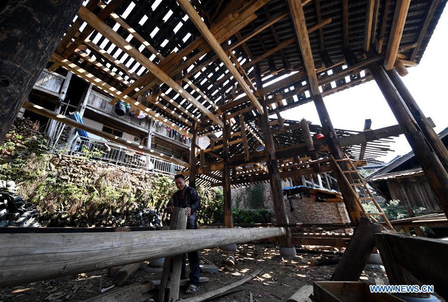 A villager does carpenter work in an old opera stage in reform in Zaidang, Qiandongnan of southwest China\'s Guizhou Province, Aug. 14, 2018. Zaidang, a village of Dong ethnic group, has encouraged its villagers to make use of idle resources to upgrade local infrastructure, in an aim to develop tourism industry and shake off poverty. (Xinhua/Wang Bingzhen)