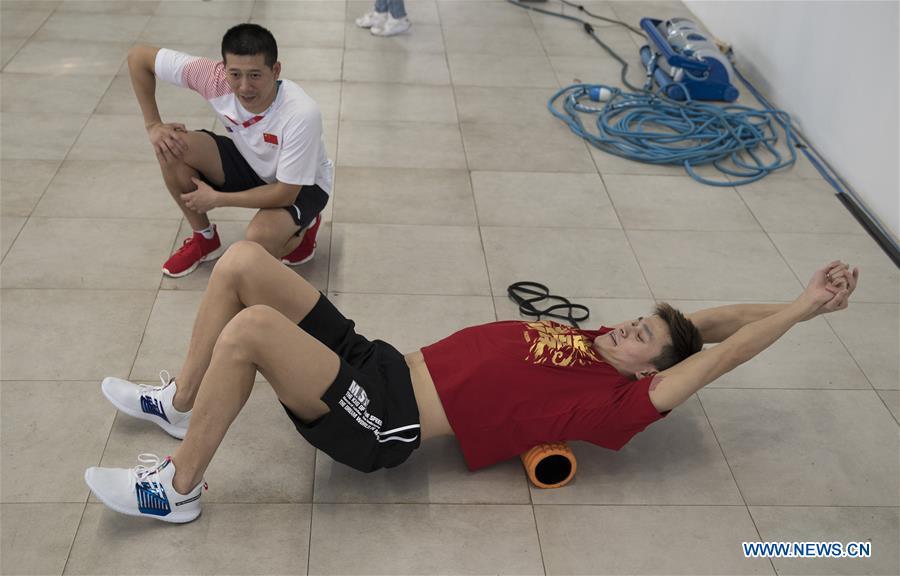 Chinese swimming athlete Sun Yang (Bottom) takes warm-up exercises for the upcoming Asian Games in Jakarta, Indonesia, Aug. 15, 2018. (Xinhua/Fei Maohua)