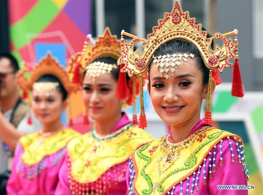 Etiquette team members in Indonesian folk costume attend flag-raising ceremonies at the Asian Games Village ahead of the 18th Asian Games in Jakarta, Indonesia, on Aug. 16, 2018. (Xinhua/Wang Yuguo)