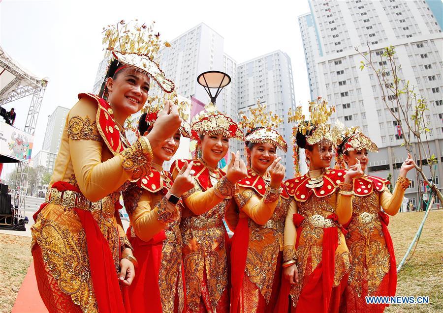 Etiquette team members in Indonesian folk costume pose for pictures at the Asian Games Village ahead of the 18th Asian Games in Jakarta, Indonesia, on Aug. 16, 2018. (Xinhua/Wang Lili)
