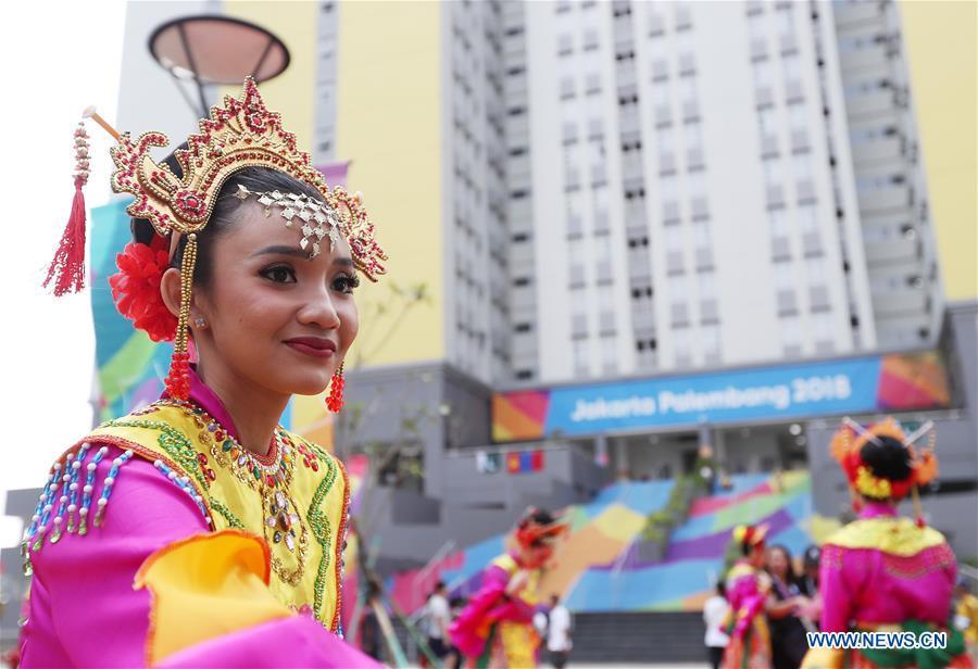 Etiquette team members in Indonesian folk costume welcome athletes at the Asian Games Village ahead of the 18th Asian Games in Jakarta, Indonesia, on Aug. 16, 2018. (Xinhua/Wang Lili)