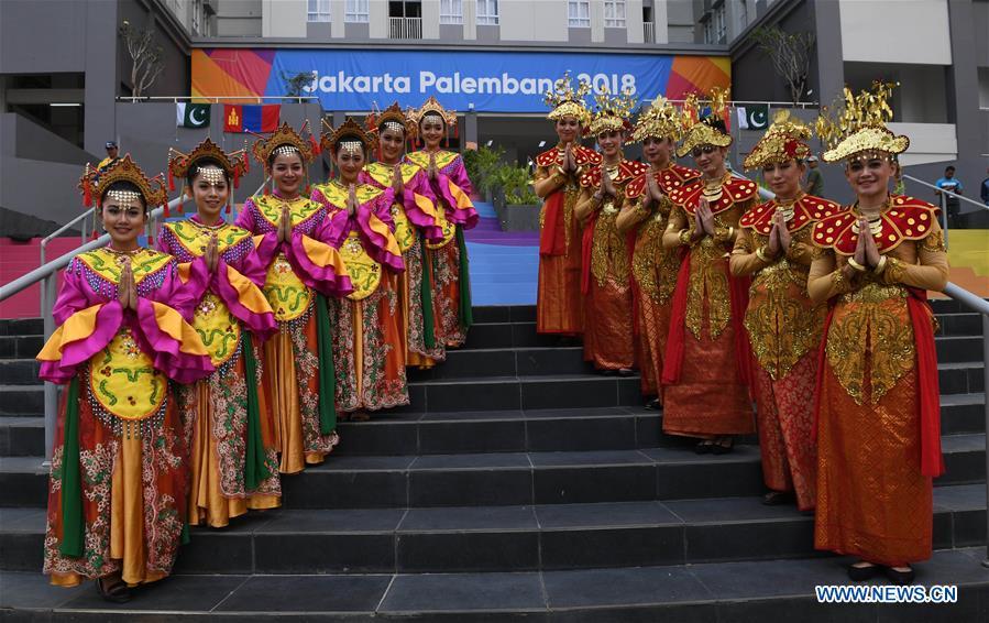 Etiquette team members in Indonesian folk costume welcome athletes at the Asian Games Village ahead of the 18th Asian Games in Jakarta, Indonesia, on Aug. 16, 2018. (Xinhua/Wang Yuguo)