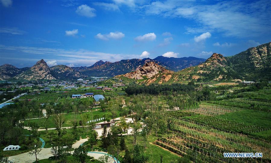 Aerial photo taken on Aug. 18, 2018 shows a park constructed on the site of an abandoned mine in Changli County, north China\'s Hebei Province. The discarded mine and damaged mountain revive as the local government has been stepping up measures to rehabilitate the ecological environment. (Xinhua/Yang Shiyao)