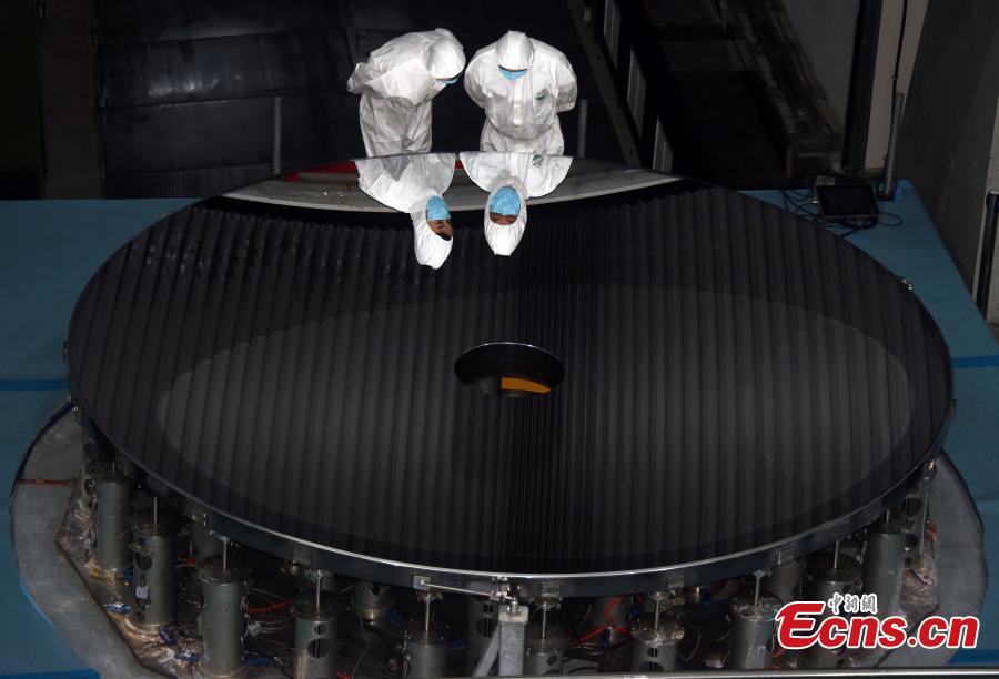 Researchers with the CAS Changchun Institute of Optics, Fine Mechanics and Physics show a silicon carbide (SiC) single mirror blank with a record-breaking diameter of 4.03m, which has passed the testing process for project acceptance, in Changchun City, Northeast China’s Jilin Province, Aug. 21, 2018. The mirror blank is a vital component for creating a large-scale telescope, and the bigger it is the more capable it is of detecting visible light bands. (Photo: China News Service/Sun Zifa)