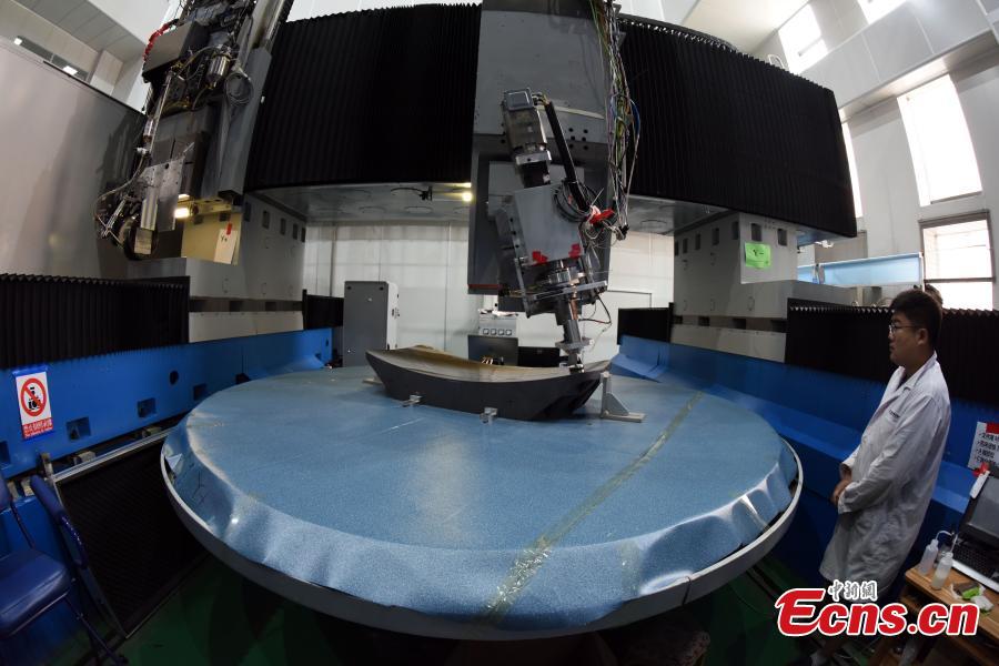 A researcher with the CAS Changchun Institute of Optics, Fine Mechanics and Physics shows the production process of a silicon carbide (SiC) single mirror blank with a diameter of 3m in Changchun City, Northeast China’s Jilin Province, Aug. 21, 2018. The mirror blank is a vital component for creating a large-scale telescope, and the bigger it is the more capable it is of detecting visible light bands. (Photo: China News Service/Sun Zifa)