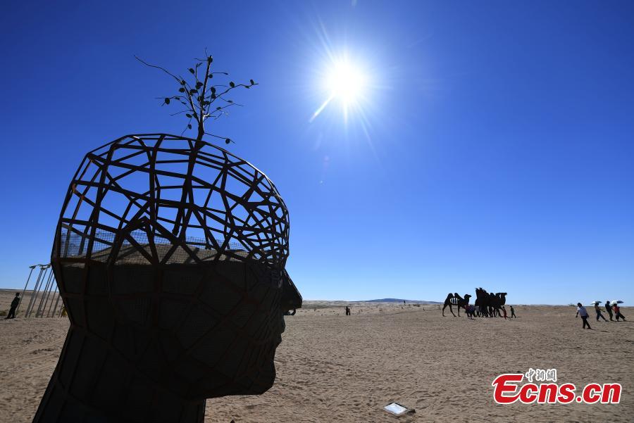 Twenty-six sculptures collected from around the world are on show in a desert in Minqin County, Northwest China’s Gansu Province, Aug. 22, 2018. The sculptures have been made from varying materials, including stainless steel, cast iron, stone and cement, and they reveal the ever-present nature of sand and its control in the county. (Photo: China News Service/Yang Yanmin)