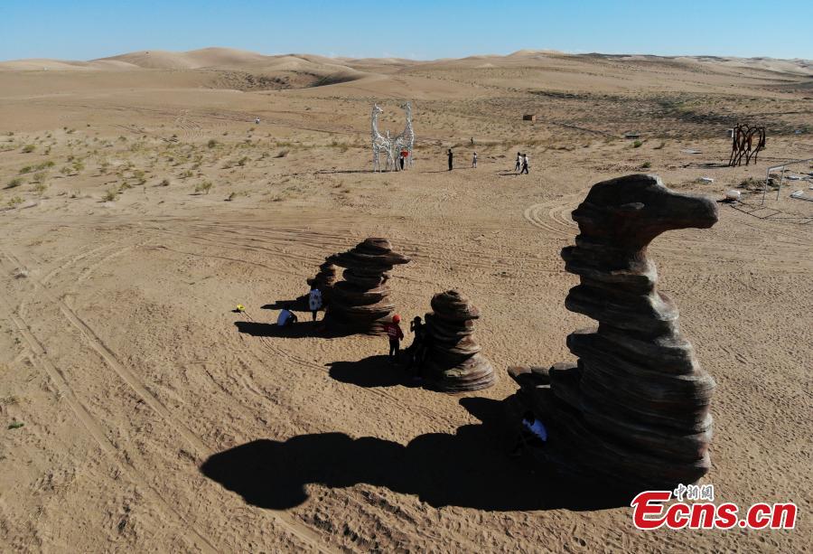 Twenty-six sculptures collected from around the world are on show in a desert in Minqin County, Northwest China’s Gansu Province, Aug. 22, 2018. The sculptures have been made from varying materials, including stainless steel, cast iron, stone and cement, and they reveal the ever-present nature of sand and its control in the county. (Photo: China News Service/Yang Yanmin)