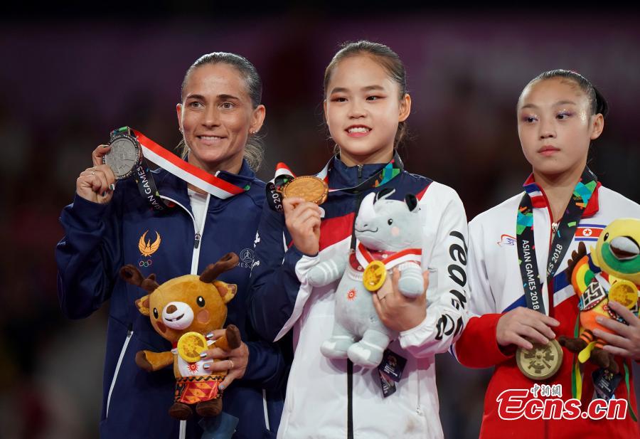 (L to R) Silver medalist Oksana Chusovitina of Uzbekistan, gold medalist Yeo Seojeong of South Korea and bronze medalist Pyon Rye Yong of the DPRK celebrate on the podium the Artistic Gymnastics Women\'s Vault in Jakarta, Indonesia on Aug.23, 2018. (Photo: China News Service/Hou Yu)