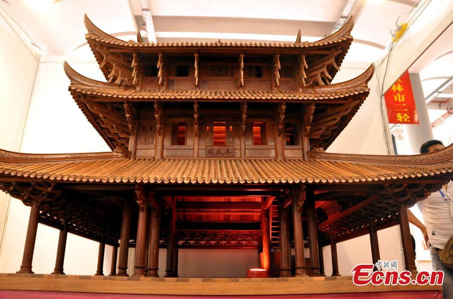 A view of a replica of Zhenwu Pavilion, made with using 3,000 wooden parts by farmer Qin Shikun, during a crafts exhibition in Nanning City, South China’s Guangxi Zhuang Autonomous Region, Aug. 24, 2018. It took Qin one and a half years to complete the miniature version of Zhenwu Pavilion, a famous Taoism pavilion for God Zhenwu in Rongxian County of Guangxi, at a scale of 1:10. (Photo: China News Service/Huang Yanmei)