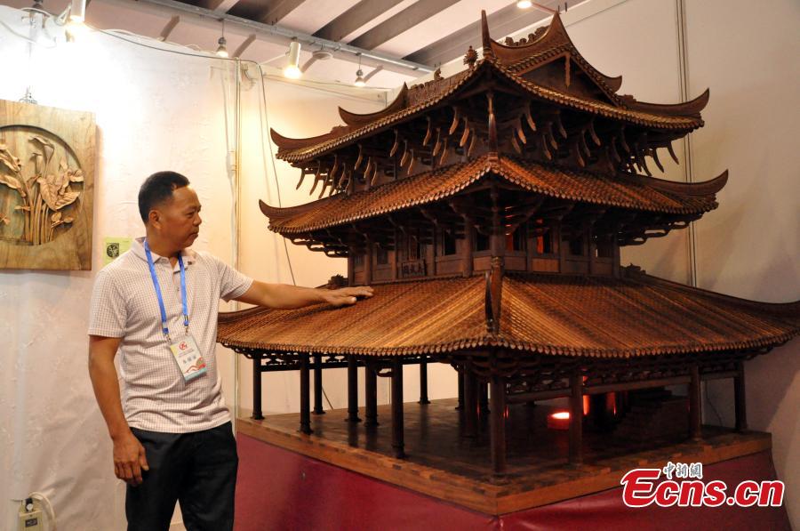 A view of a replica of Zhenwu Pavilion, made with using 3,000 wooden parts by farmer Qin Shikun, during a crafts exhibition in Nanning City, South China’s Guangxi Zhuang Autonomous Region, Aug. 24, 2018. It took Qin one and a half years to complete the miniature version of Zhenwu Pavilion, a famous Taoism pavilion for God Zhenwu in Rongxian County of Guangxi, at a scale of 1:10. (Photo: China News Service/Huang Yanmei)