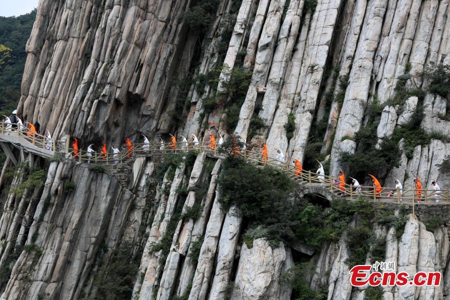 Yoga and kung fu enthusiasts perform in a cultural festival on Mount Song, home to the Shaolin Temple, in Dengfeng, Central China’s Henan Province, Aug. 25, 2018. (Photo: China News Service/Wang Zhongju)