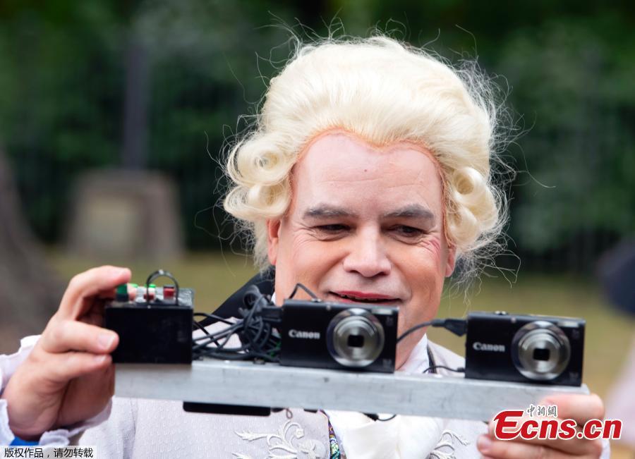 A man dressed in costume takes photos near the Friedenstein Castle, during the Baroque Festival in Gotha, Germany, Aug. 25, 2018. For the past fifteen years the city of Gotha transforms into an 18th Century city for the annual festival. (Photo/Agencies)