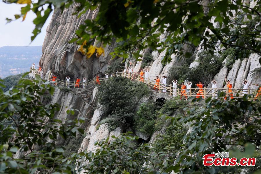 Yoga and kung fu enthusiasts perform in a cultural festival on Mount Song, home to the Shaolin Temple, in Dengfeng, Central China’s Henan Province, Aug. 25, 2018. (Photo: China News Service/Wang Zhongju)