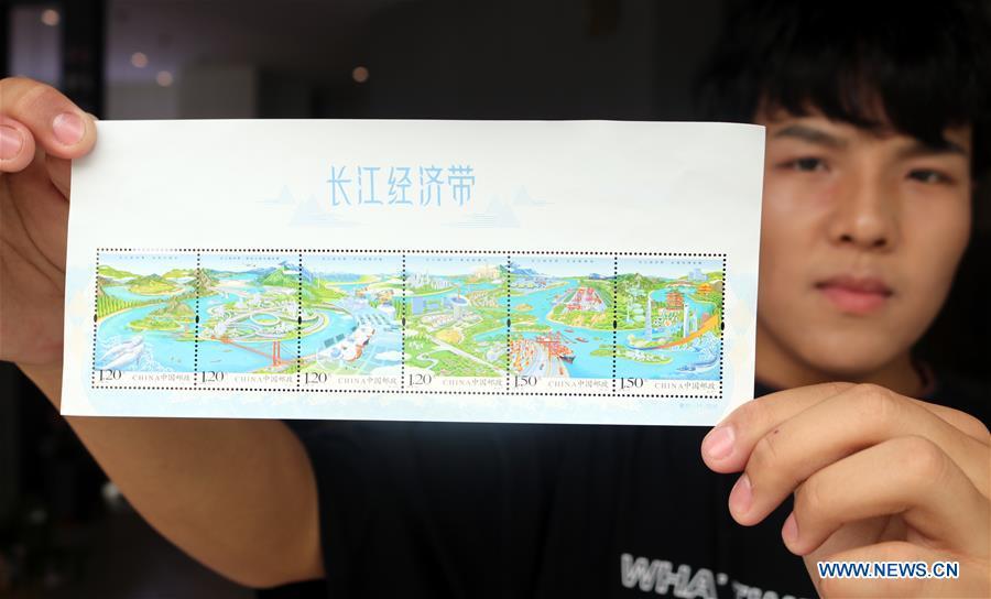 A stamp collector presents the special stamp set \