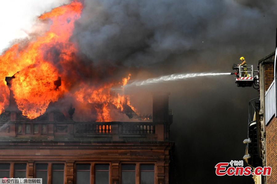 A large blaze engulfs the roof of a landmark building undergoing refurbishment in Belfast, the Northern Ireland capital, Aug. 28, 2018. The Northern Ireland Fire and Rescue Service says it was called Tuesday morning to a blaze at the Bank Buildings, home to clothing retailer Primark. Flames engulfed the roof of the structure, destroying the rooftop clock, before spreading through the five-story building. The Bank Buildings date from the late 18th century, though the current structure was built around 1900. It was nearing the end of a major renovation. (Photo/Agencies)