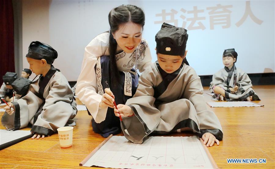 A newly-enrolled pupil learns to write a Chinese character \