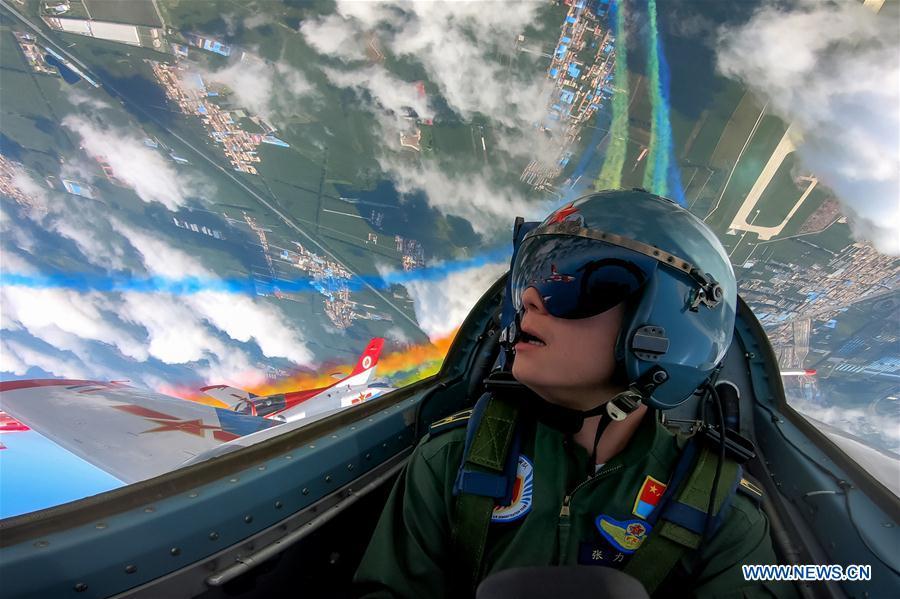 A pilot of Red Falcon Air Demonstration Team performs during an activity of opening day at the Aviation University of Air Forces in Changchun, capital of northeast China\'s Jilin Province, Aug. 30, 2018. (Xinhua/Yang Pan)