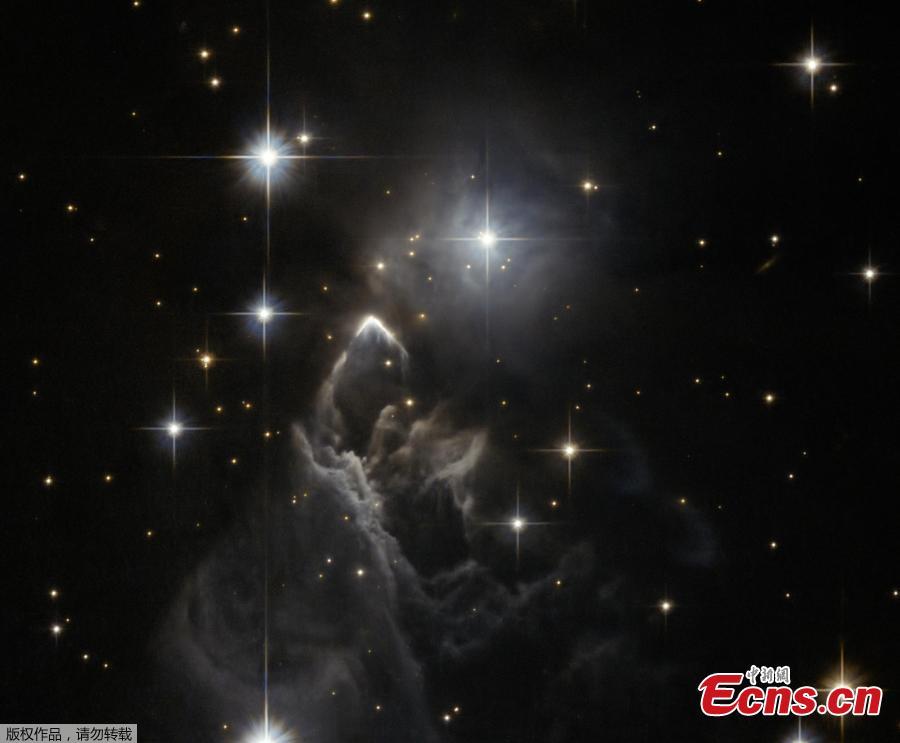 The little-known nebula IRAS 05437+2502 billows out among the bright stars and dark dust clouds that surround it in this striking image from the Hubble Space Telescope. It is located in the constellation of Taurus (the Bull), close to the central plane of our Milky Way galaxy. Unlike many of Hubble’s targets, this object has not been studied in detail and its exact nature is unclear. This faint cloud was originally discovered in 1983 by the Infrared Astronomical Satellite (IRAS), the first space telescope to survey the whole sky in infrared light. (Photo/NASA)