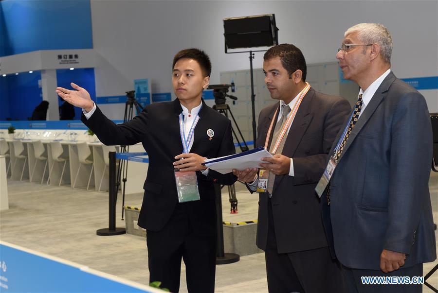 Guo Xu (1st L), a volunteer from Beijing University of Posts and Telecommunications, introduces to two Egyptian journalists about the media center for the Beijing Summit of the Forum on China-Africa Cooperation (FOCAC) in Beijing, capital of China, Sept. 3, 2018. The FOCAC Beijing Summit involves some 2,500 volunteers, most of whom are students from 32 higher education institutions. The volunteers are mainly responsible for tasks in venue services, guest reception, registration, media services and transportation. (Xinhua/Luo Xiaoguang)