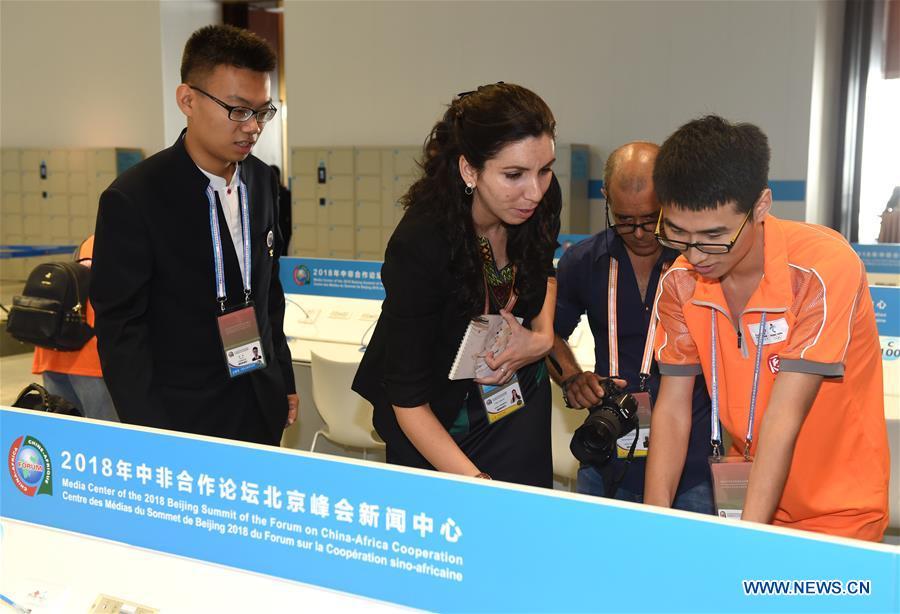 Tian Yu (1st L), a volunteer from Beijing University of Posts and Telecommunications, provides language service to journalists from Cuba at the media center for the Beijing Summit of the Forum on China-Africa Cooperation (FOCAC) in Beijing, capital of China, Sept. 3, 2018. The FOCAC Beijing Summit involves some 2,500 volunteers, most of whom are students from 32 higher education institutions. The volunteers are mainly responsible for tasks in venue services, guest reception, registration, media services and transportation. (Xinhua/Luo Xiaoguang)