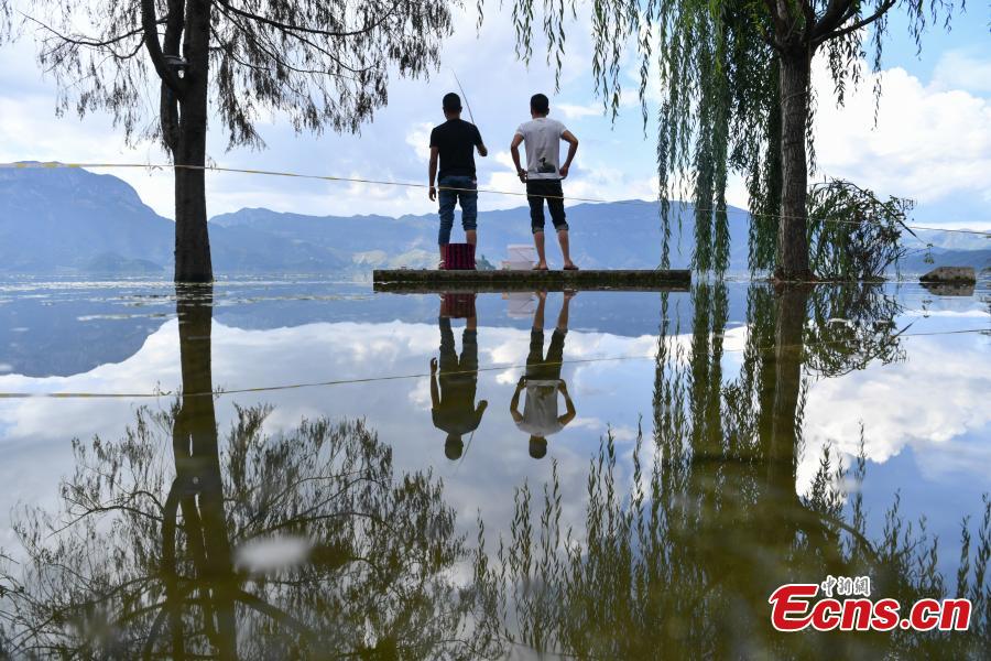 Water overflows the shores of Lugu Lake, a tourist attraction in Ninglang Yi Autonomous County, Southwest China’s Yunnan Province, Sept. 2, 2018. Local authorities have increased efforts to release more water from the lake following days of heavy rain. (Photo: China News Service/Ren Dong)