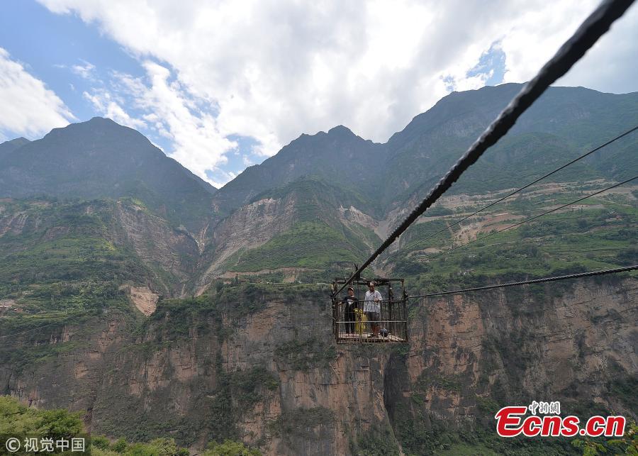 It’s goodbye dangerous, outdated ziplines and hello newly-built bridges for a river by a village in Liangshan Yi Autonomous Prefecture, Southwest China’s Sichuan Province, Sept. 1, 2018. The province has built 77 new bridges to replace ziplines ?steel cables the villagers hung from for a dangerous journey across the river. (Photo/VCG)