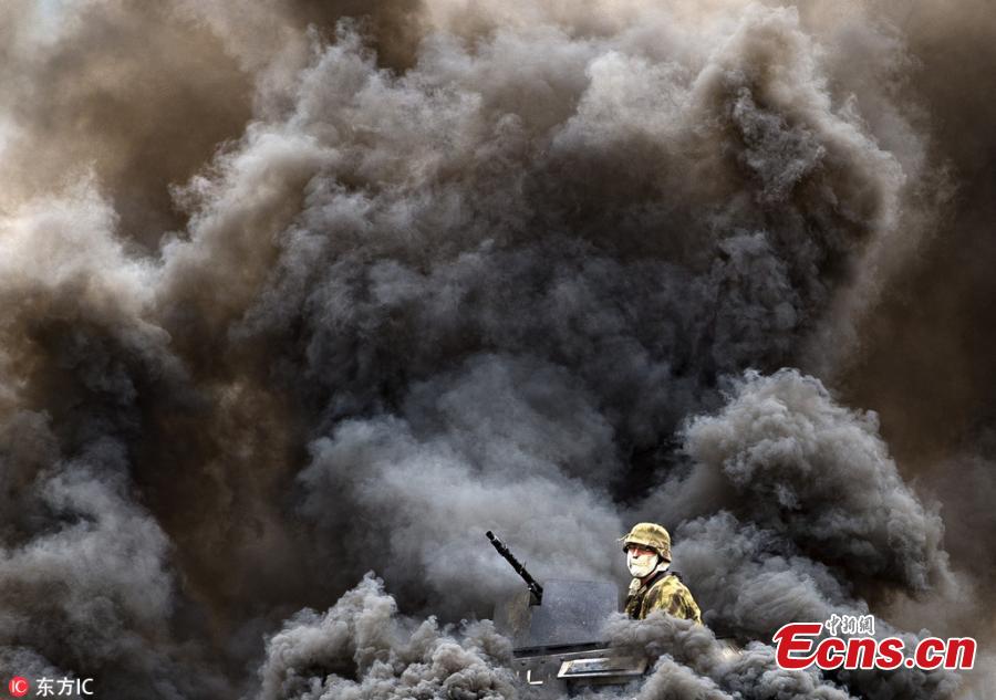 A soldier on a military vehicle in smoke is seen during the Tank Day 2018 in Lesany, Czech Republic, Sept. 1, 2018. (Photo/Agencies)