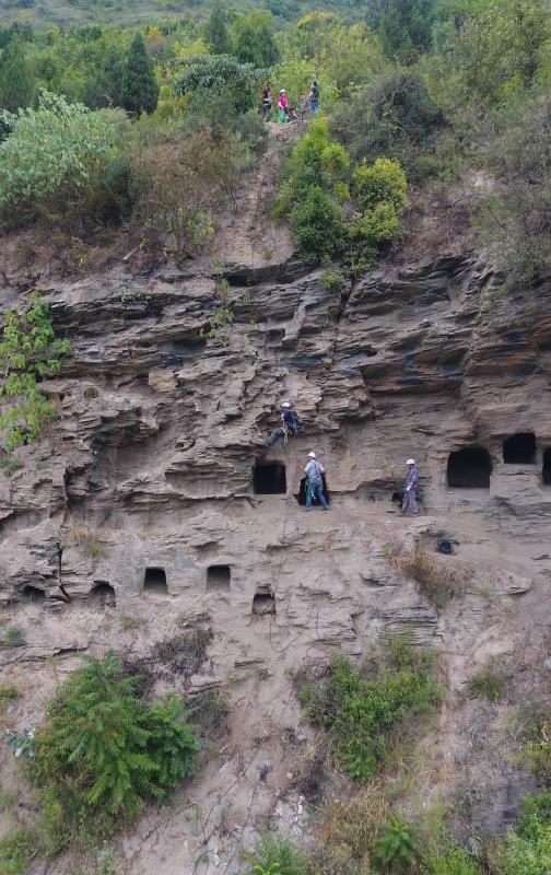 Archaeological workers are rock climbing to reach the excavation area on a cliff in Yangpitan, Yunxi county, Central China\'s Hubei Province. (Photo by Zhang Jianbo for chinadaily.com.cn)
