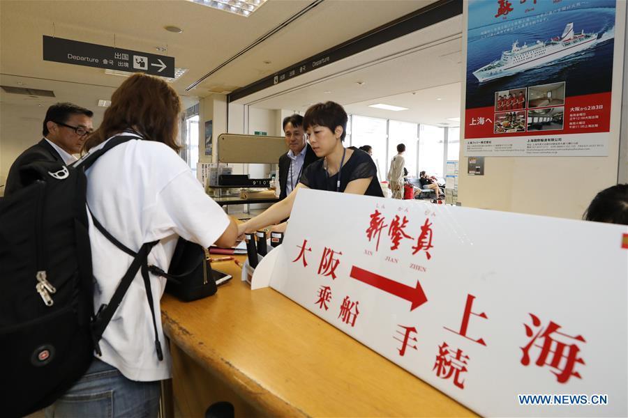 A Chinese passenger buys ticket before boarding the ferry \
