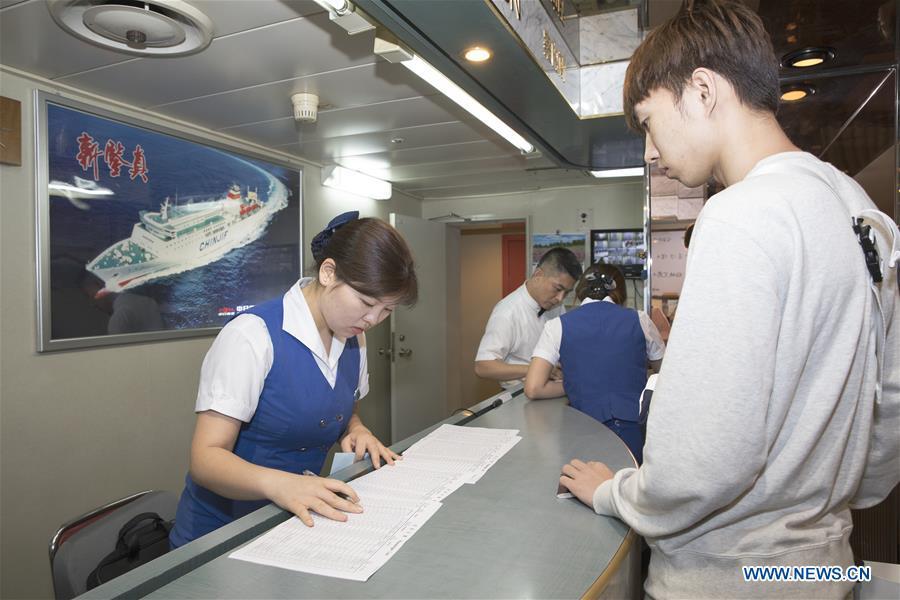 A Chinese passenger goes through boarding procedure on the ferry \