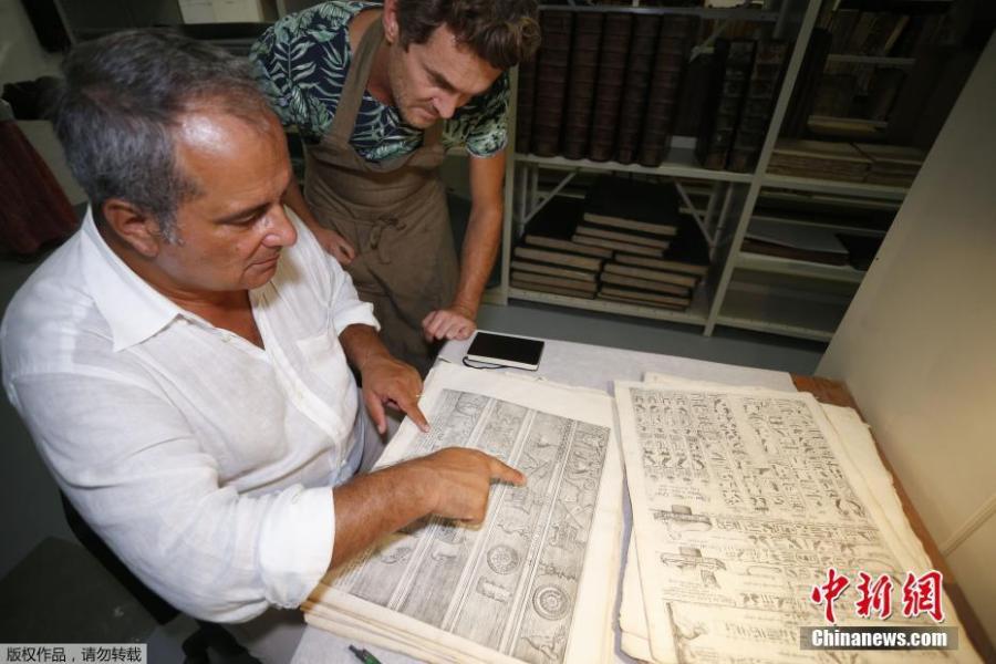 Italian Egyptologue Francesco Tiradritti (L) and Italian conservator-restorer Simone Martini look at the Thesaurus Hyeroglyphicorum book at the Ajaccio library on the French Mediterranean Island of Corsica, Sept. 7, 2018. (Photo/Agencies)