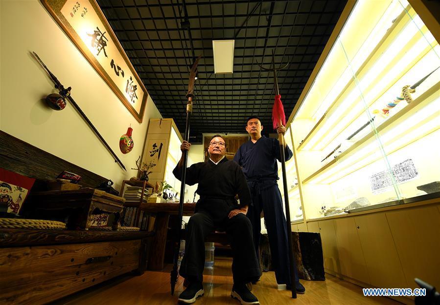 Yan Min (L) displays repaired ancient weapons with his son in Shijiazhuang, north China\'s Hebei Province, Sept. 11, 2018. Yan Min, dedicated to ancient weapon restoration for more than 30 years, has hitherto repaired over 500 pieces of ancient weapons with his son Yan Peng. Influenced by his father, Yan Peng quit his job and embarked on restoring ancient weapons in the year of 2015. The sophisticated craftsmanship of ancient weapon restoration embodies working procedures of polishing, burnishing, grinding etc. \