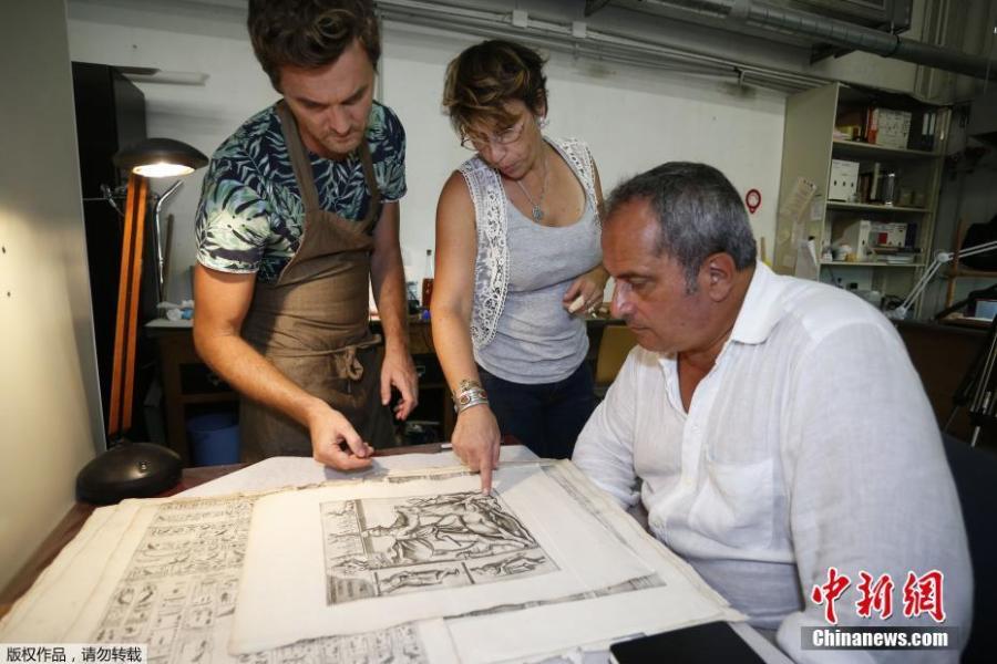 Italian Egyptologue Francesco Tiradritti (R), Vannina Schirinski-Schikhmatoff (C) in charge of the Ajaccio library restauration and conservation mission and Italian conservator-restorer Simone Martini look at the Thesaurus Hyeroglyphicorum book at the Ajaccio library on the French Mediterranean Island of Corsica, Sept. 7, 2018. (Photo/Agencies)