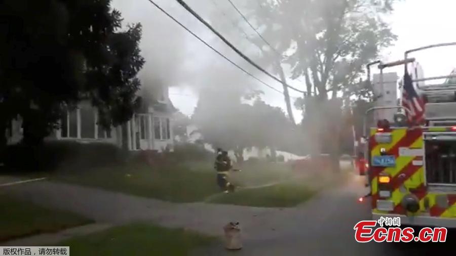 Firefighters work near a building emitting smoke after explosions in North Andover, Massachusetts, United States in this September 13, 2018 still image from social media video footage by Boston Sparks. (Photo/Agencies)