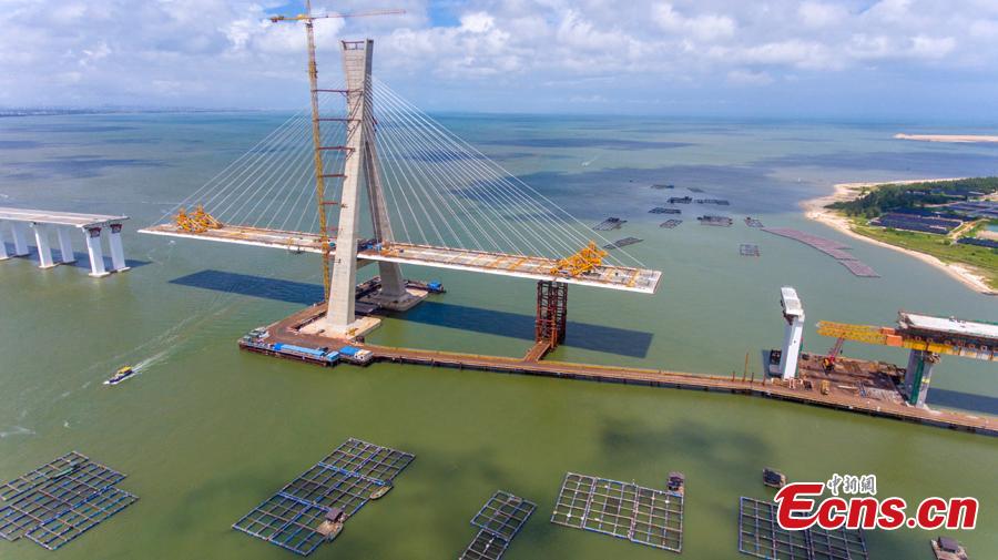 A view of the Puqian Bridge under construction in South China\'s Hainan Province, Sept. 14, 2018. Construction of the cross-sea bridge, scheduled for completion at the end of 2018, will cut the trip from Wenchang City to Haikou City from 90 minutes to about 20 minutes. Spanning a geological fault line, it’s being built to the highest standard of earthquake resistance at an investment of 3.01 billion yuan ($440 million). The 5.6-km-long bridge is expected to promote economic growth in the northern part of Hainan Province. (Photo: China News Service/Luo Yunfei)