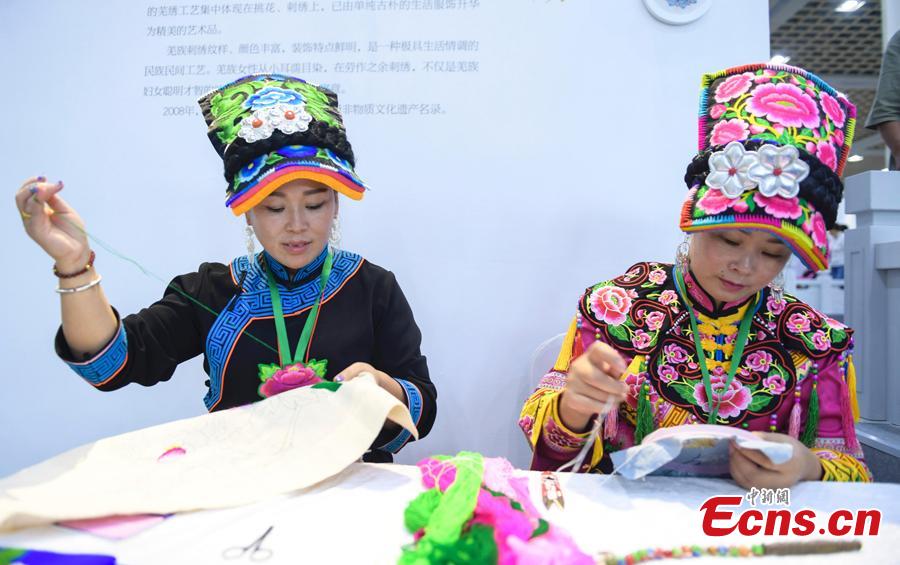Two female embroiderers show their skill at the fifth China Intangible Cultural Heritage Expo in Jinan City, Shandong Province, Sept. 13, 2018. The expo was jointly organized by the Ministry of Culture and Tourism and the Shandong provincial government. More than 200 practitioners of traditional arts and craftsmanship will showcase their skills at the expo, which will include stilt-walking, embroidery by the Qiang people and straw-weaving craftworks. (Photo: China News Service/Zhang Yong)