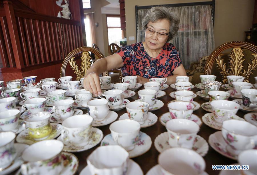 Teacup collector June Gao displays part of her teacup collections inside her house in Vancouver, Canada, Sept. 13, 2018. (Xinhua/Liang Sen)