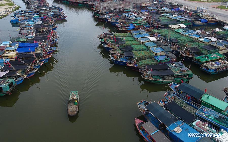 Aerial photo taken on Sept. 14, 2018 shows fishing boats berthed at a fishing port in Sanya, south China\'s Hainan Province. Mangkhut, the 22nd typhoon this year, is expected to land in south China\'s Guangdong and Hainan provinces on the night of Sept. 16. (Xinhua/Yang Guanyu)