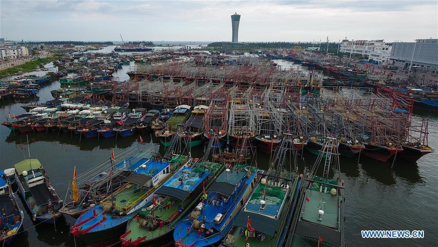 Aerial photo taken on Sept. 14, 2018 shows fishing boats berthed at a fishing port in Sanya, south China\'s Hainan Province. Mangkhut, the 22nd typhoon this year, is expected to land in south China\'s Guangdong and Hainan provinces on the night of Sept. 16. (Xinhua/Yang Guanyu)