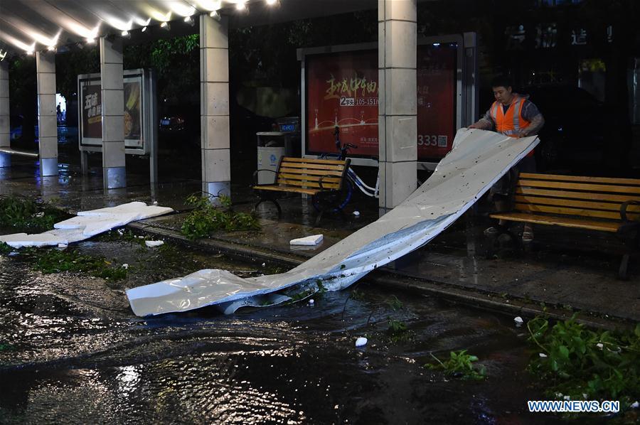 A worker clears debris of a board in Zhuhai, south China\'s Guangdong Province, Sept. 16, 2018. Super Typhoon Mangkhut landed at 5 p.m. on Sunday on the coast of Jiangmen City, south China\'s Guangdong Province, packing winds up to 162 km per hour, according to the provincial meteorological station. (Xinhua/Liang Xu)