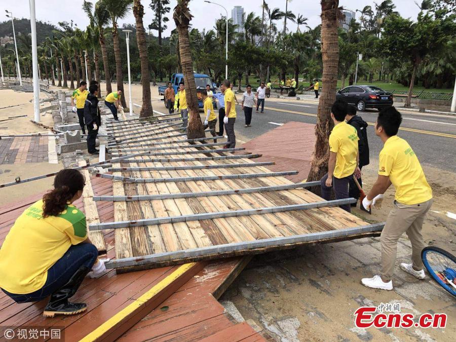 People clear a muddy road in the aftermath of Super Typhoon Mangkhut in Zhuhai City, South China’s Guangdong Province, Sept. 17, 2018. (Photo/VCG)