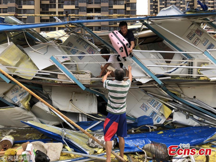 People search for their belongings in a dormitory building damaged by Super Typhoon Mangkhut in Zhuhai City, South China’s Guangdong Province, Sept. 17, 2018. (Photo/VCG)