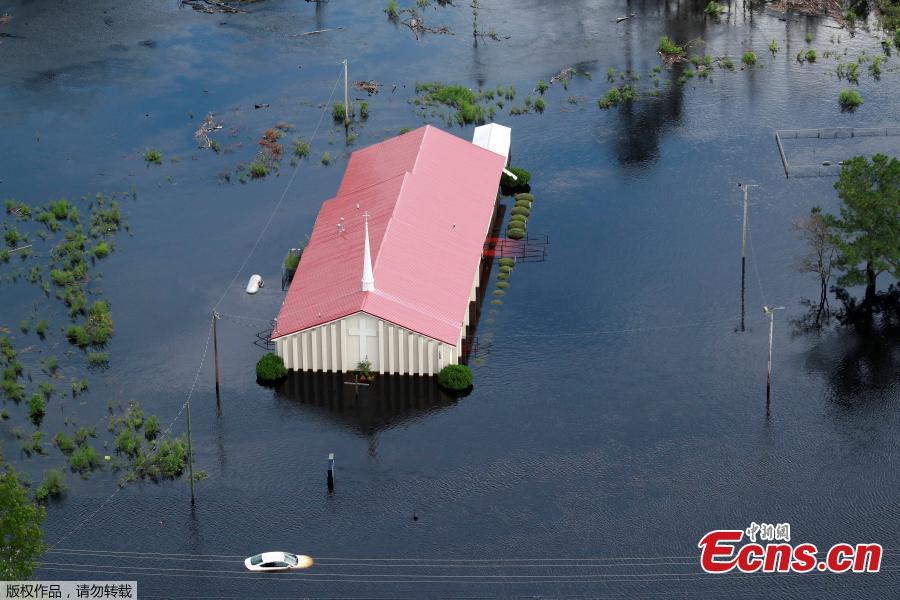 Houses sit in floodwater caused by Hurricane Florence, in this aerial picture, on the outskirts of Lumberton, North Carolina, U.S. Sept. 16, 2018. Deadly storm Florence drenched North Carolina with more downpours on Sunday, cutting off the coastal city of Wilmington, damaging tens of thousands of homes and threatening worse flooding as rivers fill to the bursting point. (Photo/Agencies)