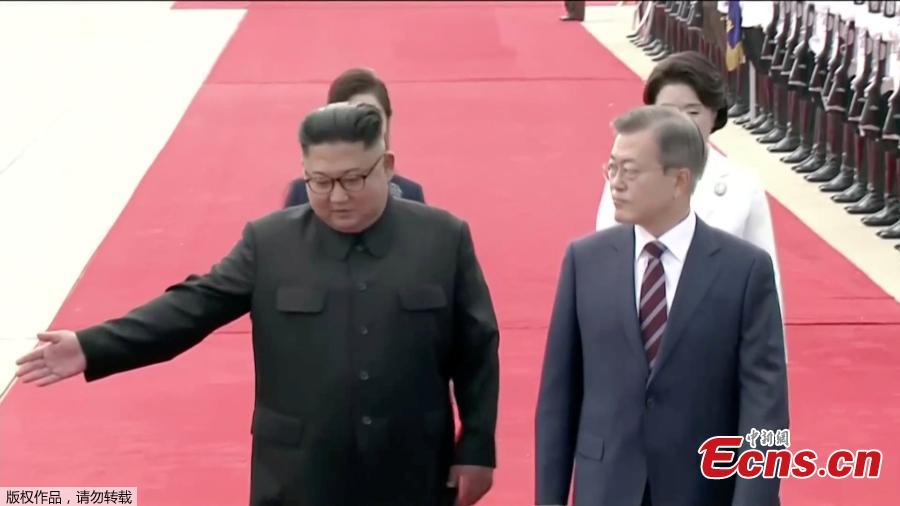 In this image made from video, South Korean President Moon Jae-in, right, is welcomed by the Democratic People\'s Republic of Korea leader Kim Jong Un for a photo on the podium upon arrival in Pyongyang, Sept. 18, 2018. Moon landed in Pyongyang for his third summit this year with Kim. (Photo/Agencies)