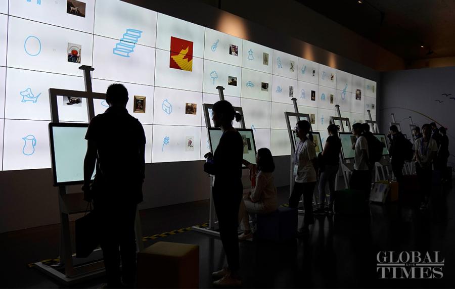 People interact with a Google painting system, which matches world-renowned paintings with people\'s sketches.
(Photo: Yang Hui/GT)